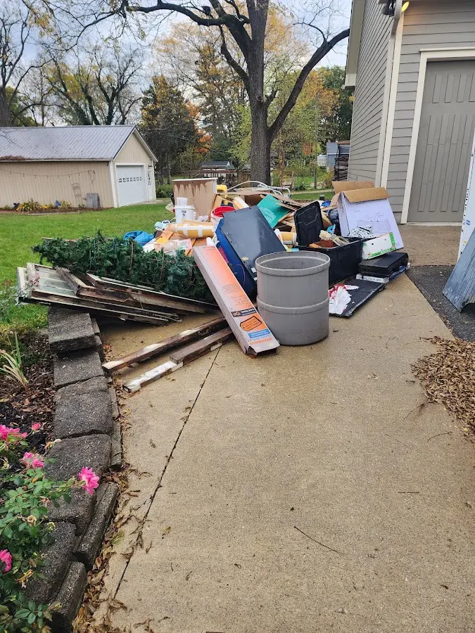Dumpster being loaded with debris for Estate Cleanout Dumpster Rental in Greencastle